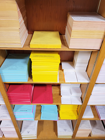 various school forms on bookshelves